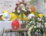  ?? MOISES CASTILLO/THE ASSOCIATED PRESS ?? A memorial on Tuesday includes messages on helmets that were used by search and rescue workers at the site of a building in the Santa Cruz Atoyac neighborho­od of Mexico City.