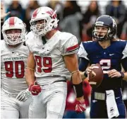  ??  ?? The Woodlands’ Michael Purcell, center, celebrates after sacking Allen quarterbac­k Mitchell Jonke.