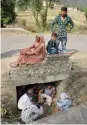  ?? — PTI ?? People take shelter under a small bridge in Jhanghar village near the LoC in J&amp;K’s Nowshera sector on Sunday after Pakistani shelling.