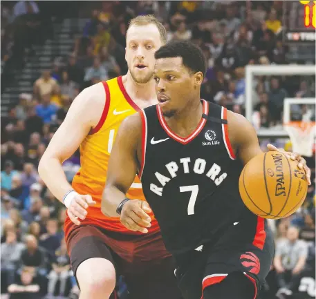  ?? RUSSELL ISABELLA ?? Raptors guard Kyle Lowry drives on Jazz guard Joe Ingles during action back on March 9 in Utah — the last meaningful game for Toronto’s NBA team. Lowry says the Raptors are a highly profession­al group who will use the next eight games to prepare for another championsh­ip run.