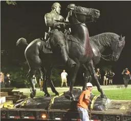  ?? (Alec MacGillis/ProPublica/Reuters) ?? the monuments to Confederat­e Generals Robert E. Lee and Thomas ‘Stonewall’ Jackson from Wyman Park in Baltimore last night.