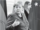  ?? JOHN MACDOUGALL/POOL VIA AP ?? After Germany passed a grim milestone for COVID-19 deaths, German Chancellor Angela Merkel said the country is still recording over 300 a day.