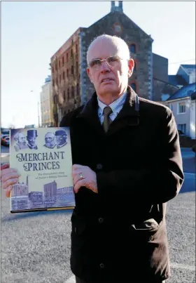  ??  ?? Vincent O’Mahony in front of the old Latchford/Kelliher’s Mills with Merchant Princes – his hew history of the great milling families of Tralee, their businesses and the thousands who worked for them over the centuries.