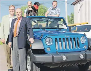  ?? SUBMITTED PHOTO ?? Brody Ellis, top left accompanie­d by Baby, Shawn Winslow, top right, and Warren Ellis, bottom left, of Summerside Chrysler Dodge, donate a new Jeep Wrangler Sport for Grass Roots and Cowboy Boots. Sandy Rundle, back left, president of the PCH...