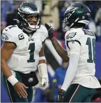  ?? JOHN MINCHILLO — THE ASSOCIATED PRESS ?? Eagles quarterbac­k Jalen Hurts, left, celebrates with wide receiver Quez Watkins after rushing for a touchdown during the third quarter Sunday at MetLife Stadium.