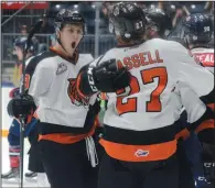  ?? NEWS PHOTO RYAN MCCRACKEN ?? Medicine Hat Tigers Zach Fischer (left), Mark Rassell and Clayton Kirichenko celebrate Kirichenko’s first-period goal during Saturday’s WHL game against the Lethbridge Hurricanes at the Canalta Centre.