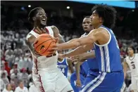  ?? The Associated Press ?? ■ Arkansas forward Makhel Mitchell (22) tries to pass the ball past Kentucky forward Jacob Toppin (0) during the second half Saturday in Fayettevil­le.