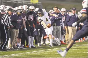  ?? H John Voorhees III / Hearst Connecticu­t Media ?? Framingham State quarterbac­k Adam Wojenski tries to stay in bounds as he runs down the sideline against WestConn in Danbury on Saturday.