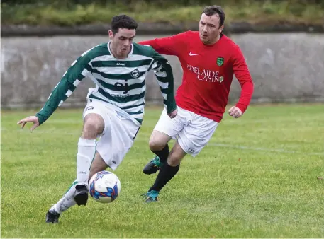  ??  ?? Strand Celtic’s Aaron O’Boyle in action with James Cullen of MCR. Pic: Donal Hackett.