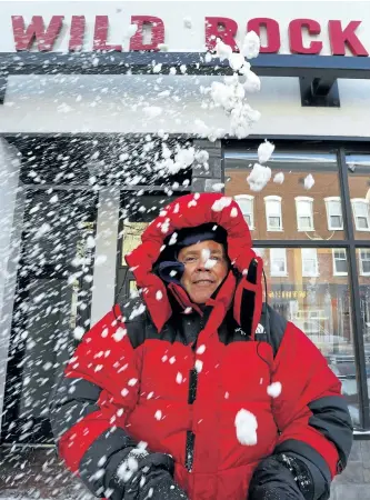  ?? CLIFFORD SKARSTEDT/EXAMINER ?? City police Deputy Chief Tim Farquharso­n throws snow in the air after being outfitted at Wild Rock Outfitters for his upcoming 12-hour Stand With Tim event raising funds for Youth Emergency Shelter, Brock Mission and the Warming Room on Thursday. Farquharso­n will brave the cold downtown from 4 p.m. to 4 a.m. on Jan. 26, spending 12 hours outside to raise awareness about homelessne­ss.