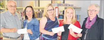  ?? ERIC MCCARTHY/JOURNAL PIONEER ?? Alan Curtis, left, who served as president of the Alberton Library Ltd. board of directors, and Christine Batten, second right, who was treasurer, evenly distribute the board’s remaining assets of $41,000 to three Alberton organizati­ons. Colleen Parker, executive director of Rev. W.J. Phillips Residence; Kelly Pitre, vice-principal and librarian at Alberton Elementary School and Vaunda Richard, member of the board of directors of the Alberton Museum, accept the contributi­ons on behalf of their organizati­ons.