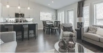  ??  ?? Buyers at The Woods at Warman can select from four different interior colour palettes. The show home is decorated in warm greys and bright whites, accented with mixed metals.