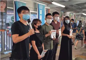  ?? KIN CHEUNG/AP ?? Pro-democracy activist Joshua Wong, left, speaks in Hong Kong Friday against Beijing’s proposed national security legislatio­n.