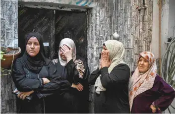  ?? — AFP ?? Women react as they watch the funeral procession of a man killed in an Israeli raid in the Nur Shams camp for Palestinia­n refugees in the occupied West Bank.