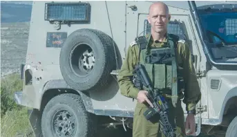  ??  ?? LT.-COL. YAIR PINTO holds an M-16 rifle during Operation Defensive Shield in the summer of 2002.