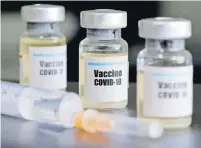  ?? Picture: REUTERS ?? Small bottles labeled with a “Vaccine COVID-19” sticker and a medical syringe are seen in this illustrati­on.