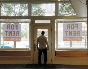  ??  ?? Steve Battista, Revtown’s co-founder and chief marketing officer, looks out the window of a vacant storefront on Butler Street in Lawrencevi­lle that the startup is considerin­g as a pop-up or brick-and-mortar store for Revtown.