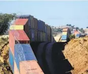  ?? ROSS D. FRANKLIN AP FILE ?? A long row of double-stacked shipping containers provide a wall between the U.S. and Mexico in Arizona’s remote San Rafael Valley.