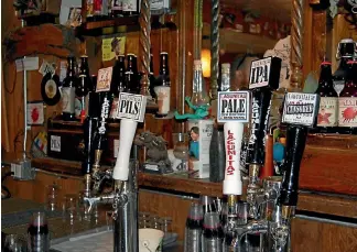  ?? GEOFF GRIGGS ?? Some beer taps in the tasting room at Lagunitas’ Petaluma brewery.