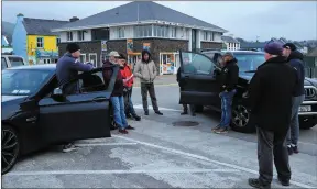  ??  ?? 7.30pm Sunday evening: fishermen discuss a warning from Gardaí that they could be arrested for blocking access to Dingle pier.