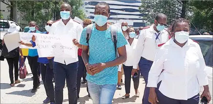  ?? ?? The nurses committee marching towards the Police Headquarte­rs where they delivered a petition to NATCOM.