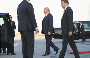  ?? Pablo Martinez Monsivais / Associated Press ?? President Trump walks across the tarmac following his arrival on Air Force One in Helsinki, Finland.