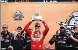  ??  ?? Kyle Busch raises the trophy in Victory Lane after winning the NASCAR Xfinity Series auto race at the Circuit of the Americas in Austin, Texas, on May 22. (AP)