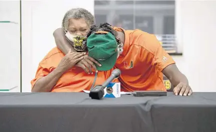  ?? MICHAELLAU­GHLIN/SUN SENTINEL ?? American Heritage safety James Williams hugs his grandmothe­r, Ira Williams, after signing to play football at the University of Miami on Wednesday.