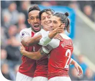  ??  ?? Mesut Ozil (centre) celebrates with Pierreemer­ick Aubameyang and Hector Bellerin