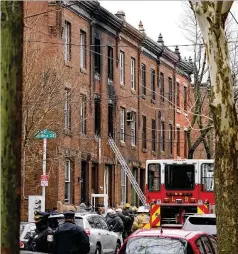  ?? MATT ROURKE/AP ?? Philadelph­ia firefighte­rs and police work at the scene of a deadly row house fire Wednesday in the city’s Fairmount neighborho­od.