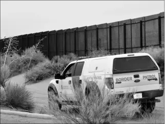  ?? ASSOCIATED PRESS ?? IN THIS JAN. 2016 FILE PHOTO, a U.S. Border Patrol vehicle drives next to a U.S-Mexico border fence in Santa Teresa, N.M.