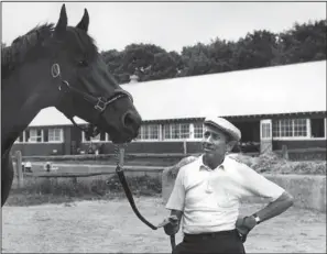  ?? The Associated Press ?? CHAMPION TRAINER: Trainer John Nerud poses with champion Dr. Fager. Nerud, a thoroughbr­ed racing pioneer who trained Dr. Fager and helped create the Breeders’ Cup, has died, the National Museum and Racing Hall of Fame said in a statement Thursday. He...