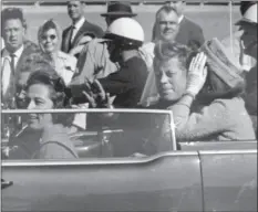  ??  ?? In this Nov. 22, 1963, file photo, President John F. Kennedy waves from his car in a motorcade in Dallas. Riding with Kennedy are First Lady Jacqueline Kennedy (right), Nellie Connally (second from left), and her husband, Texas Gov. John Connally (far...