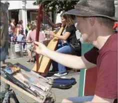  ??  ?? Tony Robinson from Wexford painting the harpist in the Bullring in Wexford on Saturday afternoon.