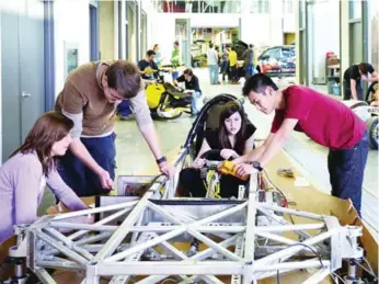  ??  ?? Midnight Sun solar car team members work inside the University of Waterloo Student Design Centre.