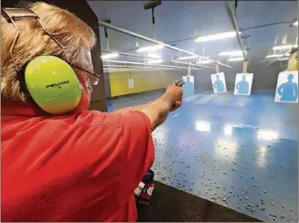  ?? PHOTOS BY CURTIS COMPTON / CCOMPTON@AJC.COM ?? Jim Cronin takes to the gun range after attending the Community Bible Church monthly men’s study group meeting.