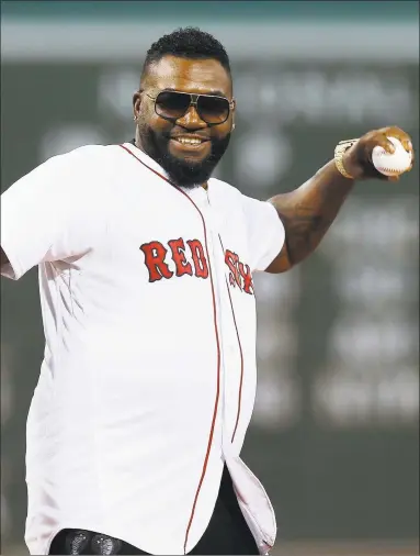  ?? Michael Dwyer / Associated Press ?? David Ortiz throws out a ceremonial first pitch before Monday’s game between the Red Sox and Yankees on Monday at Fenway Park in Boston.