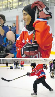  ??  ?? Fatima Al Ali was given one of NHLer T.J. Oshie's sticks and took some shots with the Washington Capitals while a flock of reporters filmed it all.