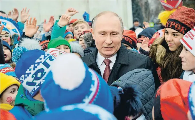 ?? ALEXEI DRUZHININ / AP ?? El presidente ruso, Vladímir Putin, charla con los niños que asistieron ayer al espectácul­o de Año Nuevo en el palacio del Kremlin, en Moscú