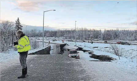  ?? DAN JOLING THE ASSOCIATED PRESS ?? A car is trapped on a collapsed section of Minnesota Drive in Anchorage on Friday after Alaska was struck by back-to-back earthquake­s.