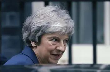  ?? Matt Dunham/Associated Press ?? British Prime Minister Theresa May leaves 10 Downing St. heading to Parliament on Wednesday in London. Ms. May convinced her divided Cabinet that it had a choice between backing a draft Brexit deal or plunging the U.K. into political and economic uncertaint­y.