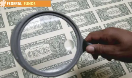  ?? — Reuters ?? One dollar bills are inspected under a magnifying glass during production at the Bureau of Engraving and Printing in Washington.