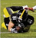  ?? DON WRIGHT / ASSOCIATED PRESS ?? What appeared to be a TD by Pittsburgh’s Jesse James last week against New England was voided after he seemed to lose his grip on the ball.