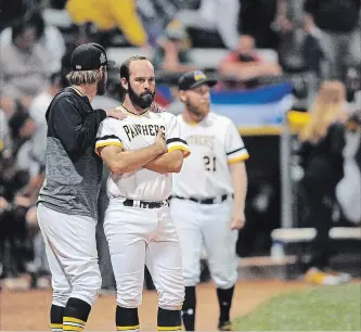  ?? DAVID BEBEE WATERLOO REGION RECORD ?? A dejected Panthers second baseman Mike Andrulis is comforted by Ryan Douse as he watches the Barrie Baycats celebrate winning their fifth straight IBL crown at Jack Couch Park.