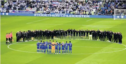  ?? SIMON GALLOWAY ?? Leicester City players and staff stand with Cardiff City players and match officials during the minute’s silence