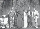 ?? GEORGE BRICH/AP ?? Kenny Baker (as R2-D2), from left, Anthony Daniels (as C-3PO), Peter Mayhew (as Chewbacca), Carrie Fisher, Harrison Ford, and Mark Hamill during the filming of the CBS-TV special “The Star Wars Holiday” in Los Angeles on Nov. 13, 1978