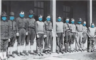  ?? SHUTTERSTO­CK ?? Medical men wearing masks on Nov. 19, 1918 at Army Hospital No. 4. Fort Porter, New York, during the 1918-19 'Spanish' Influenza pandemic.
