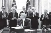  ?? ERIN SCHAFF Getty Images pool ?? From left, Treasury Secretary Steven Mnuchin, Senate Majority Leader Mitch McConnell, R-Ky., House Minority Leader Kevin McCarthy, R-Calif., Vice President Mike Pence, and Rep. Kevin Brady, R-Texas, applaud President Donald Trump on March 27 during a bill-signing ceremony for the $2 trillion CARES Act.