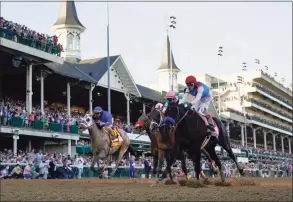  ?? Jeff Roberson / Associated Press ?? John Velazquez riding Medina Spirit, right, leads Florent Geroux on Mandaloun, Flavien Prat riding Hot Rod Charlie and Luis Saez on Essential Quality to win the 147th running of the Kentucky Derby at Churchill Downs, May 1, in Louisville, Kentucky.