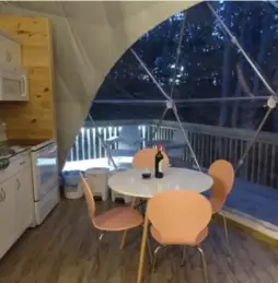  ??  ?? Inside the TreePods, birch-coloured wood floors and a floor-to-ceiling picture “window” in the open-plan kitchen/living room make it feel part of the forest.